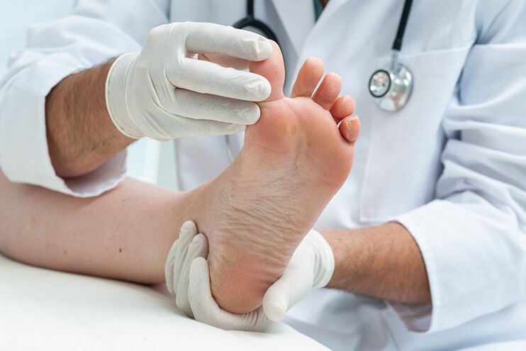 Dermatologist examines the patient's legs